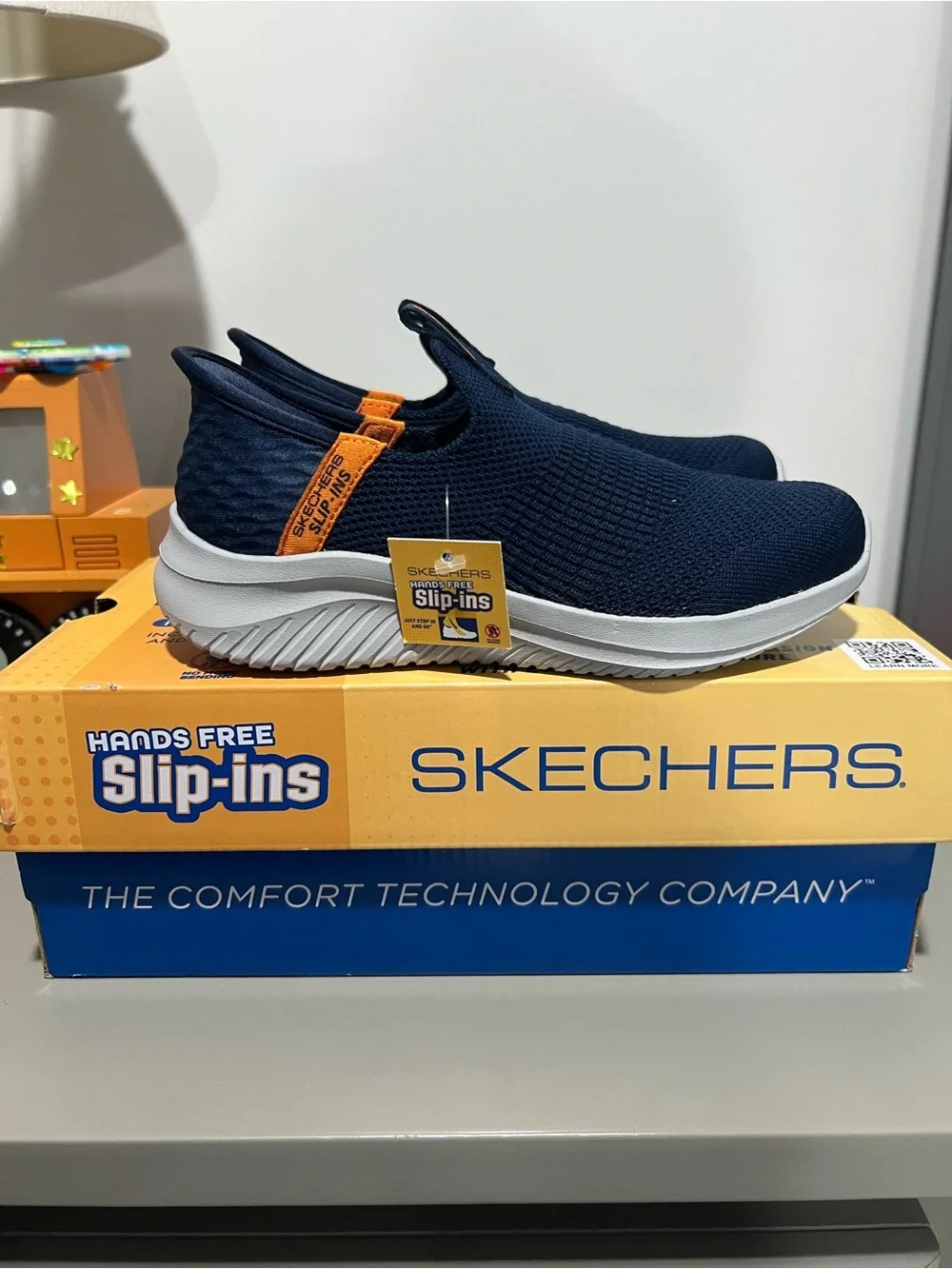 Skechers Kids Navy Slip-On Sneakers with Orange Pull Tab